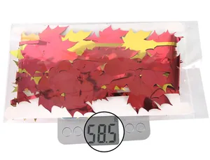Detail view of packaged red and gold maple leaf foil curtains weighing 58.5 grams