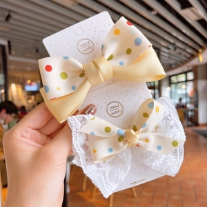 Two-piece colorful polka dot ribbon and lace bow hair clips for girls displayed on card