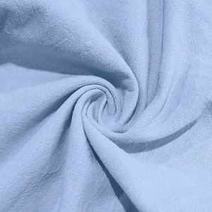 Macro shot of light blue linen fabric showing breathable texture and weave patterns