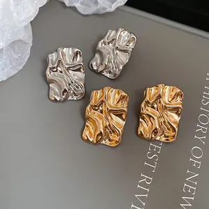 Minimalist square crinkle metal stud earrings in gold and silver with lava texture finish