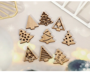 Detail view of various laser-cut wooden Christmas tree ornaments in natural finish