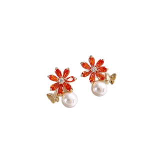 Boucles d'oreilles fleurs en perles avec pierres orange et détail papillon doré chic