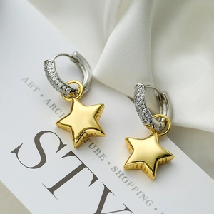 Elegant asymmetric silver hoop earrings with gold star pendants and sparkling zircons