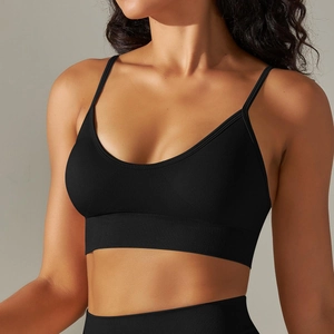 Detail of black seamless knitted sports bra with thin straps and ribbed band support