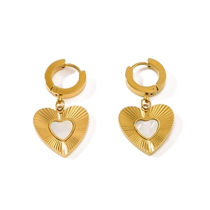 Golden heart-shaped metal textured earrings with white shell inlay on a white background