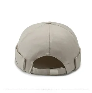Detail view of the beige docker hat back featuring an adjustable silver metal buckle