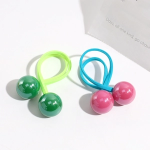 Detail shot of green and pink elastic hair ties with colorful double beads