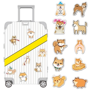 Detail of cute Shiba Inu stickers applied on a suitcase with various cartoon expressions