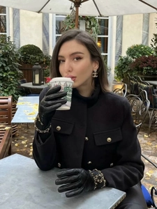 Elegant black wool blazer with gold buttons and matching quilted leather gloves with chains