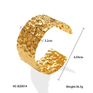 Detail shot of 3.2cm wide hammered gold stainless steel cuff showing dimensions and weight