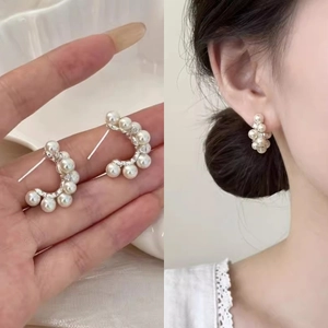 Elegant C-shaped silver pearl earrings with crystals featuring a minimalist French design