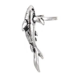 Macro shot of vintage fish ear cuff with oxidized silver texture and scale detail