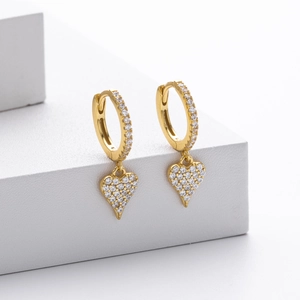 Elegant gold heart earrings with white cubic zirconia set on white geometric blocks