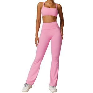 Pink quick-dry yoga set featuring a thin-strap sports bra and flared high-waist pants