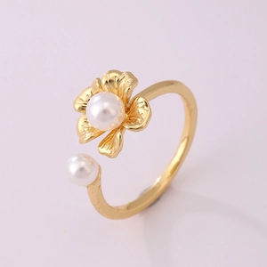 Detail of 18K gold-plated open ring featuring a floral design and white round pearl
