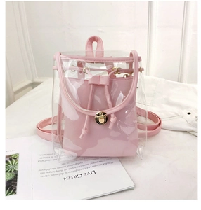 Detail showing transparent PVC backpack with pink leather inner pouch and gold hardware