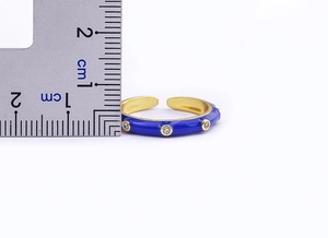 Detail view showing 3mm gold-plated open ring width with blue enamel and white zircon stones