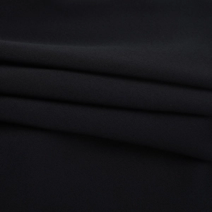 Close-up of black textile fabric detail showing soft texture and smooth drape quality
