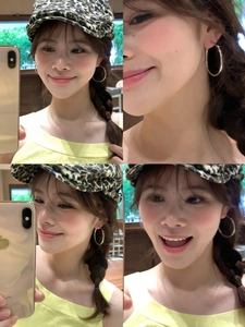 Collage of a model wearing minimalist silver hoop earrings from various angles