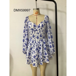 Close-up of blue floral dress with V-neckline, ruched details, and puff sleeves