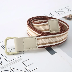 Striped canvas belt with double D-ring buckle on a lifestyle magazine background