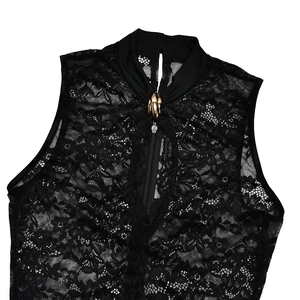 Detailed close-up of lace bodysuit with high neck, gold ornament and front zipper