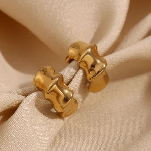 Detail of 18K gold plated stainless steel earrings with irregular wave texture