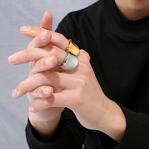 Minimalist wide teardrop ring in 18k gold and silver finish on hand with mirror polish