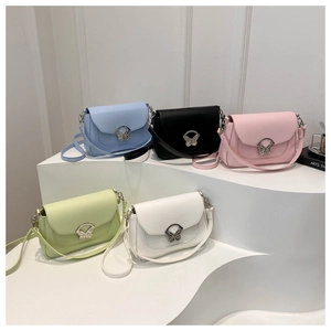 Detail showing five colors of retro crossbody bags with a butterfly metal clasp closure