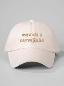 Close-up of brown embroidered Movida a Cervejinha text on light pink cotton baseball cap