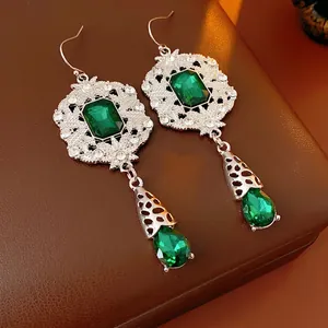 Vintage emerald long drop earrings with silver plating and crystal detailing on leather