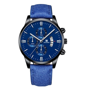 Macro detail of men's quartz watch showing navy blue dial and silver hands with date window