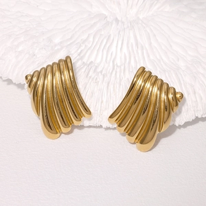 French style gold plated stainless steel shell earrings with ribbed texture on white plate