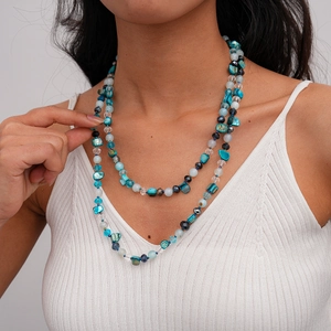 Close-up of double-layer beaded necklace with shells and colorful glass beads