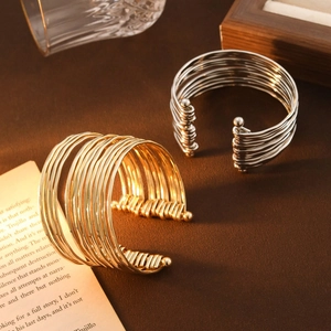 Multilayer wavy C-shaped open cuff bracelet in gold and silver finish with metal beads