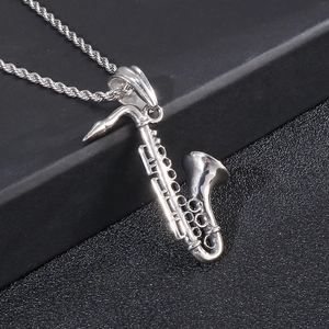 Polished stainless steel saxophone pendant necklace for men on a black textured background
