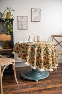 Close-up of thick sunflower jacquard round tablecloth with elegant beige tassel fringe