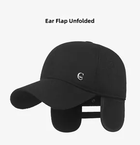 Detail view of winter baseball cap showing foldable earflaps and metal C logo