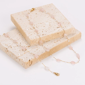 Gold stainless steel chain necklace featuring pink crystals and pearls on stone blocks