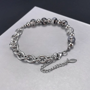 Macro shot of stainless steel bead bracelet with lobster clasp and S.Steel hallmark tag