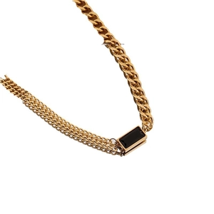 Gold multi-strand bracelet featuring a black rectangular stone set in polished titanium steel