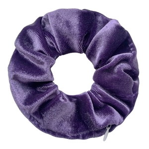 Detailed view of purple velvet scrunchie featuring a functional hidden zipper pocket