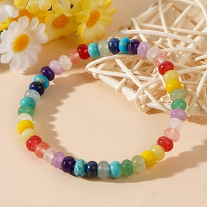 Rainbow gemstone abacus bead bracelet with colorful chakra beads on a natural background
