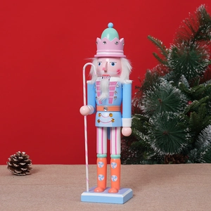 Close-up of a 30cm pastel wood nutcracker soldier with glitter and faux fur details