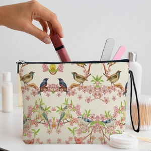 Floral makeup bag with bird print made of cotton linen featuring a zipper and wrist strap