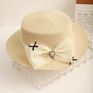 French style boater straw hat for women with pearl bow detail and ribbon for summer beach