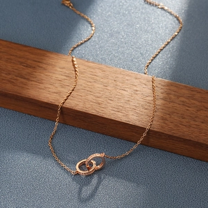 Minimalist double interlocking ring necklace in rose gold with shimmering pavé crystal accents