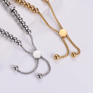 Adjustable stainless steel beaded bracelet with crystal accents in gold and silver