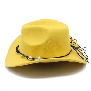 Detail of yellow wool fedora cowboy hat with shell beads and black tassel accent
