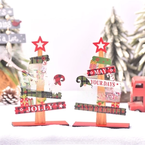 Detail of wooden Christmas tree desktop ornaments with festive seasonal text and star motifs